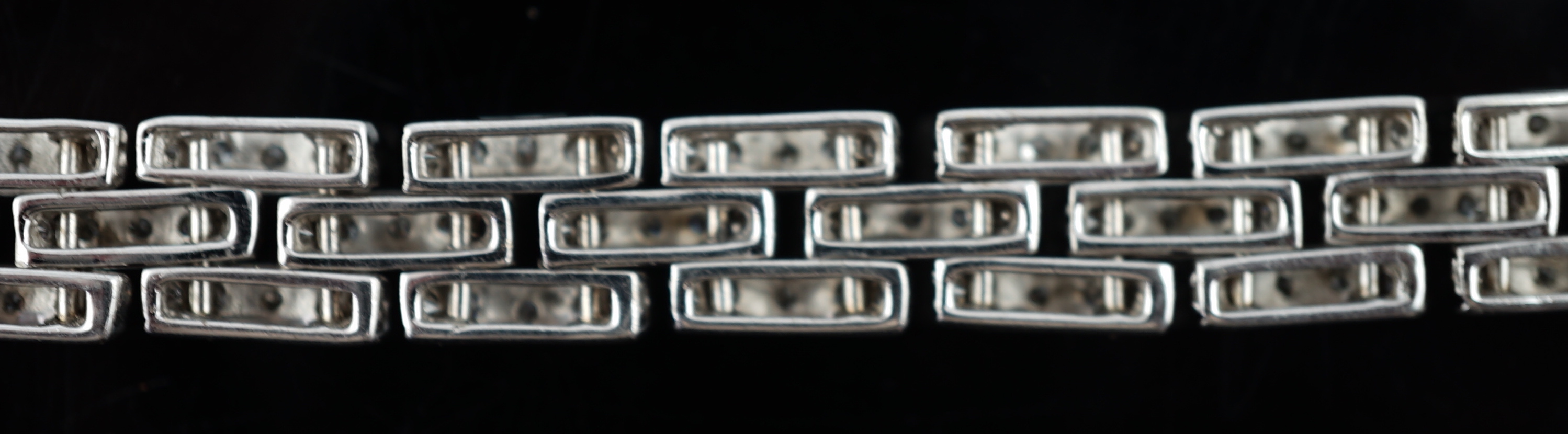 An 18k white gold and diamond chip set triple row bracelet